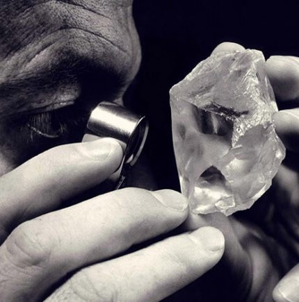 Diamond dealer inspecting rough diamond