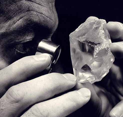 Diamond dealer inspecting rough diamond
